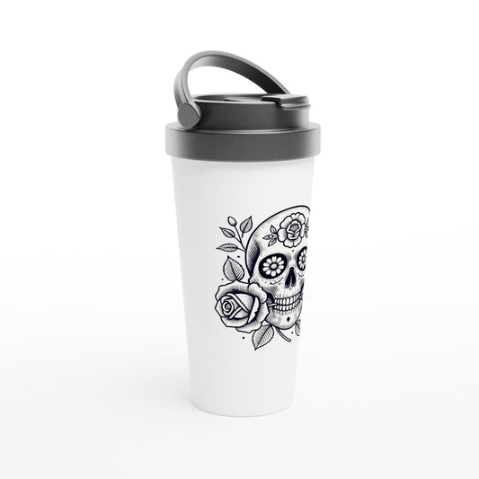 A stylish 15oz stainless steel travel mug featuring a bold skull graphic and elegant flowers, in the style of old fashioned tattoo art. White with a black lid and handle. Maintains the temperature of either hot or cold drinks.